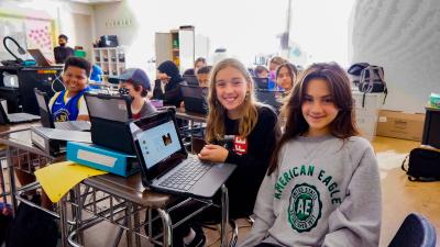 Students pose with laptop
